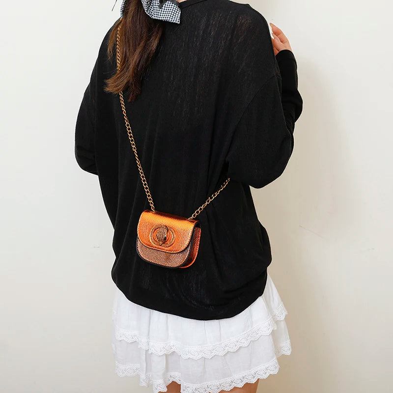 Classic Women Handbag Leather Crossbody Bag worn with a black sweater and white skirt, featuring a stylish chain strap.