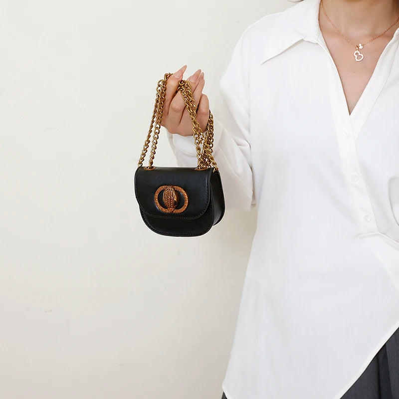 Classic Women Handbag Leather Crossbody Bag held by a woman in a white shirt, showcasing elegant design and gold chain.
